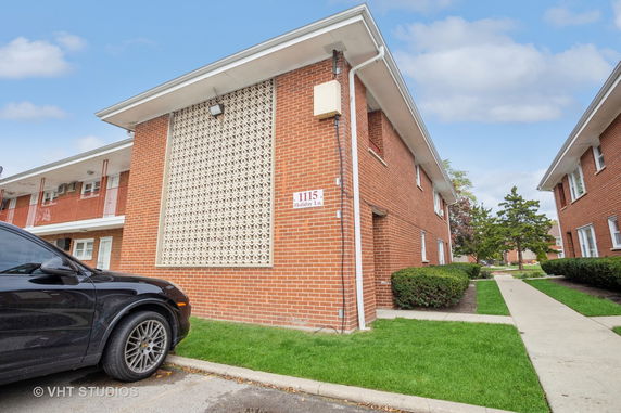 Front view of a two-story brick building with unique wall pattern.