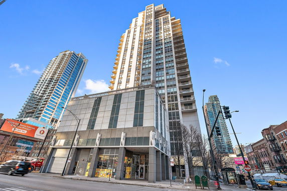 Front view of a tall multi-story building with a modern design.