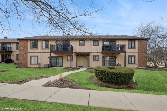 Front view of a two-story residential building with balconies.