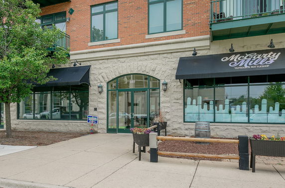 Front view of a building with large windows and awnings.