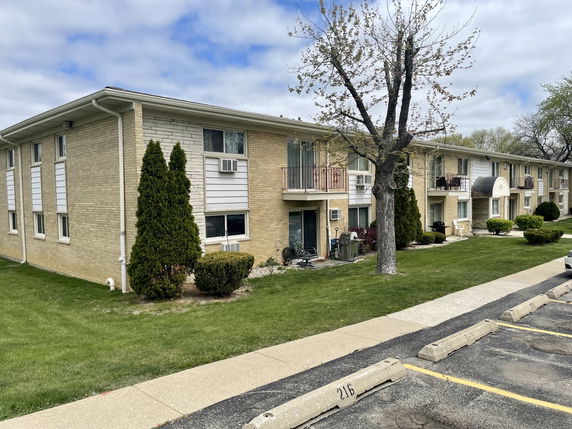 Front view of a two-story apartment building with balconies.