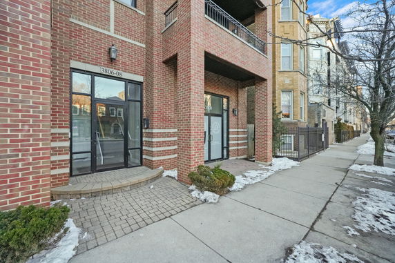 Front view of a brick building with entrance doors.
