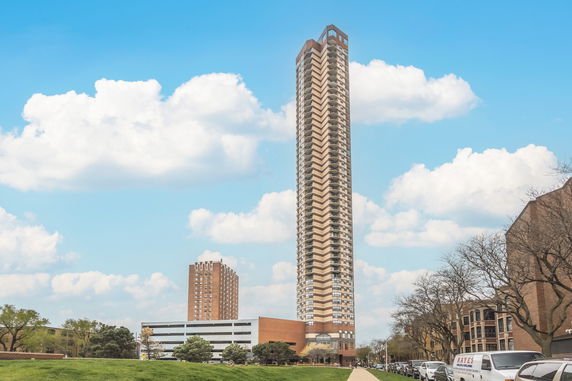Front view of a tall multi-story building with a distinct design.