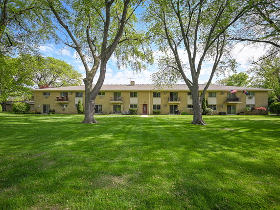 Front view of a two-story apartment building with a flat roof.