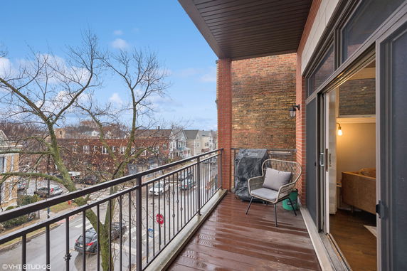 View from a balcony overlooking residential street.