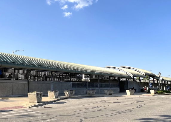 Front view of a long structure with a curved roof.