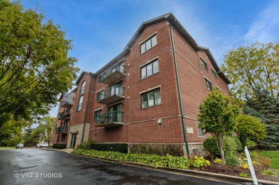 Front view of a multi-story brick building with balconies.