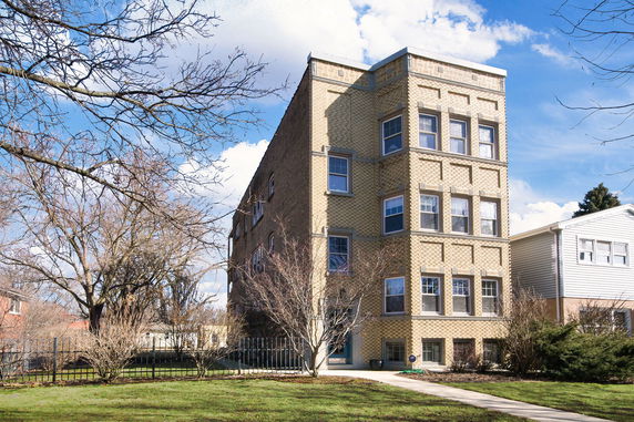 Front view of a three-story brick apartment building.