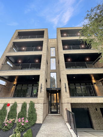 Front view of a multi-story building with balconies.