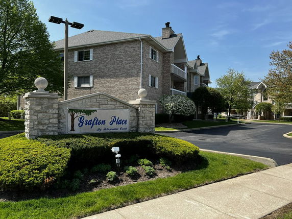 Front view of a multi-story residential building with a brick exterior.