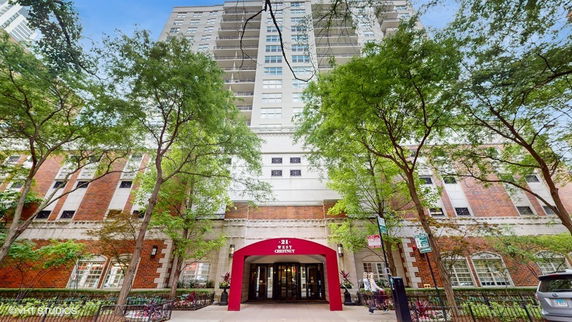 Front view of a multi-story building with a red entrance canopy.