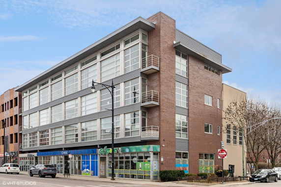 Front view of a multi-story commercial and residential building.