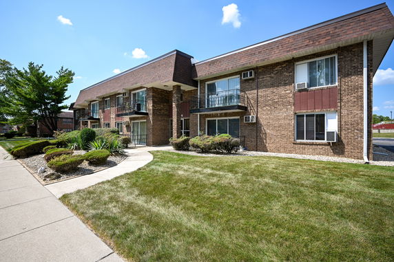Front view of a two-story apartment building with balconies.