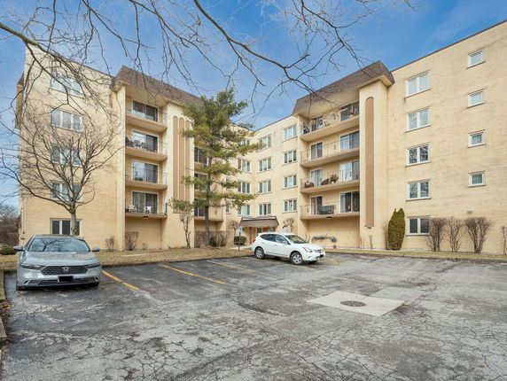Front view of a multi-story residential building with balconies.