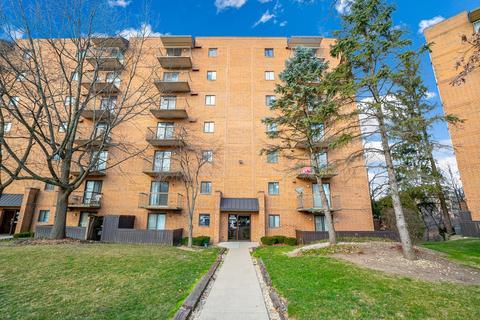 Front view of a multi-story apartment building with balconies.