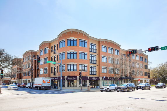 Front view of a multi-story commercial building at a street intersection.