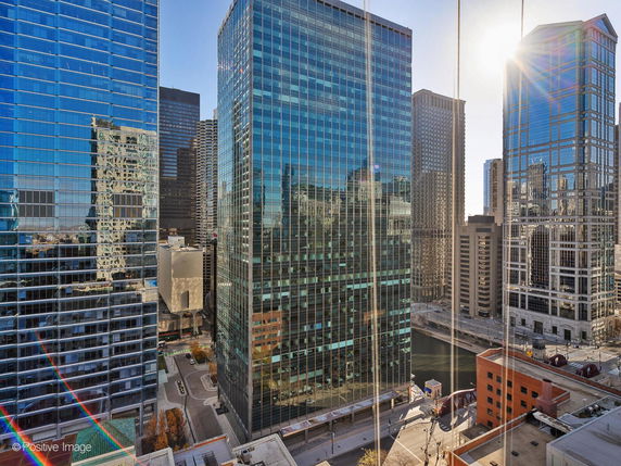 Panoramic view of tall glass skyscrapers in a city.