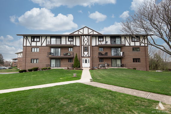 Front view of a multi-story residential building with balconies.
