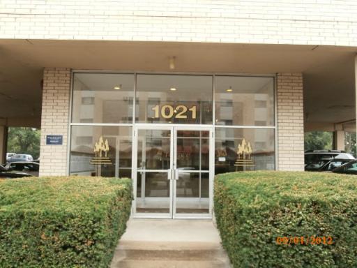 Front view of a building with glass entrance and number 1021 displayed above the door.