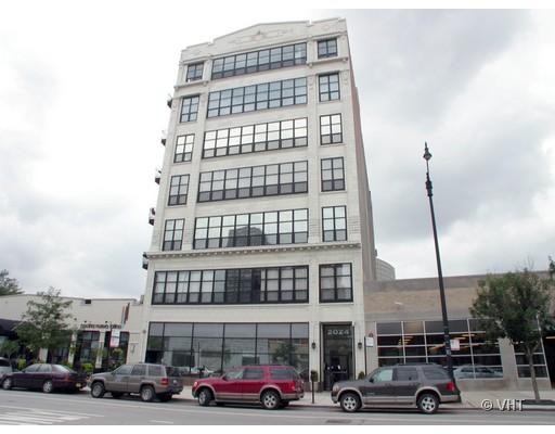 Front view of a multi-story building with large windows.