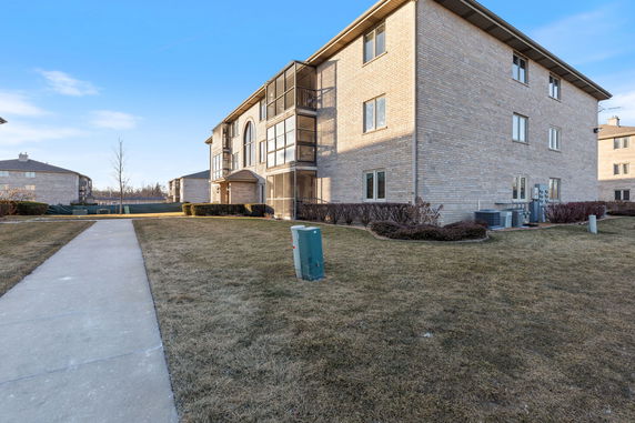 Front view of a multi-story brick apartment building.