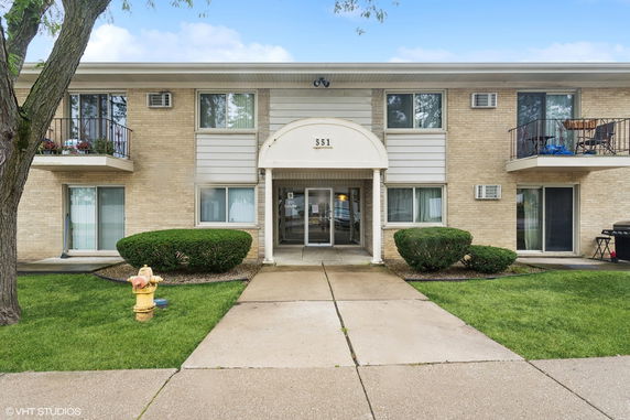 Front view of a two-story apartment building with a central entrance.