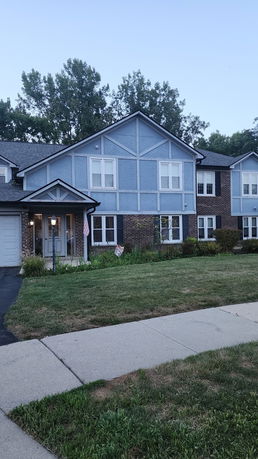 Front view of a two-story house with a garage.
