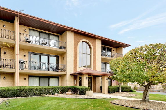 Front view of a three-story building with balconies.
