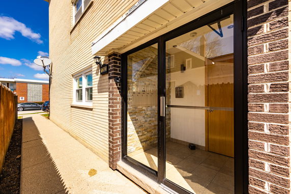 Front view of a building entrance with a glass door.