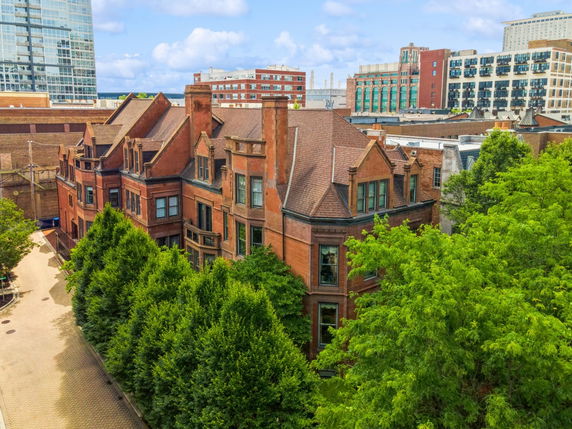 Front view of a multi-story brick building with detailed architectural features.