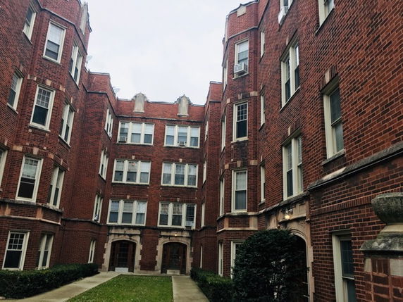Front view of a multi-story brick residential building.