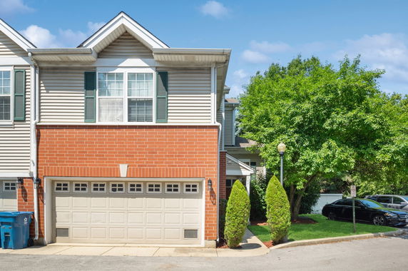 Front view of a house with a double garage and brick facade.