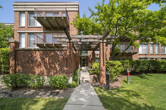 Front view of a multi-story brick building with balconies.