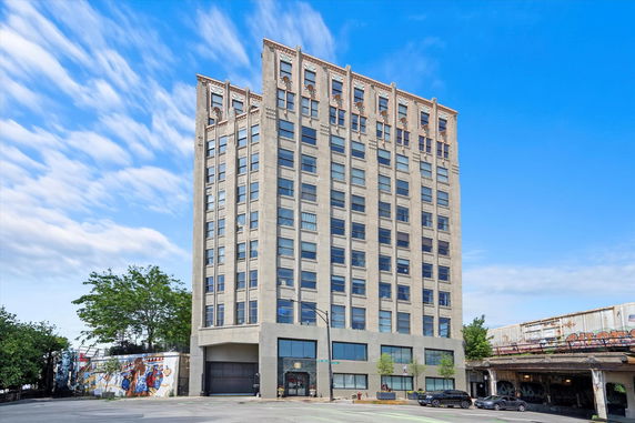 Front view of a multi-story building with large windows.