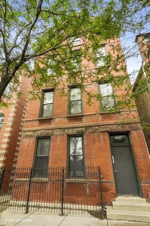 Front view of a three-story brick building.