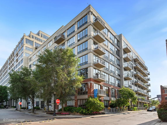 Front view of a multi-story apartment building with balconies.
