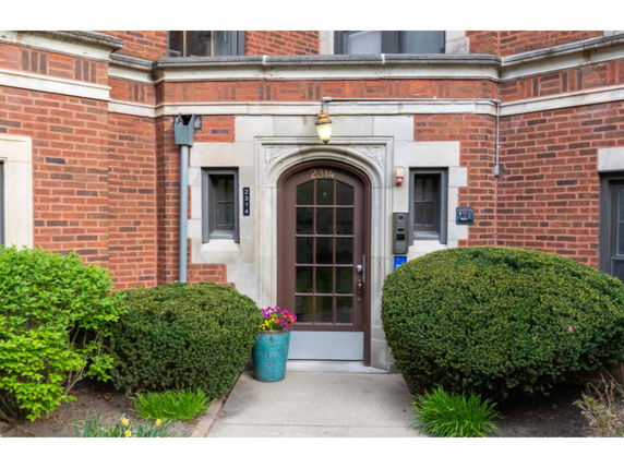 Front view of a brick building with an arched doorway.