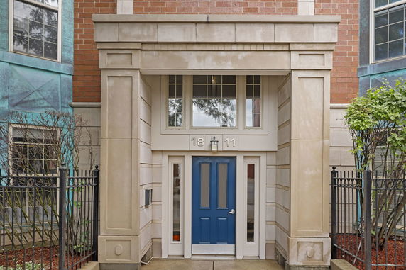 Entrance of a building with a blue door and surrounding architectural details.