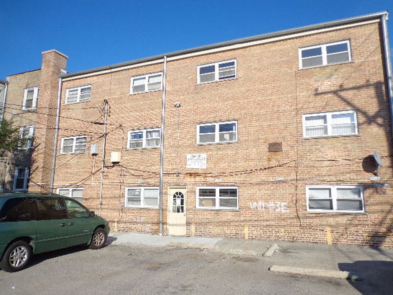 Front view of a three-story brick building.