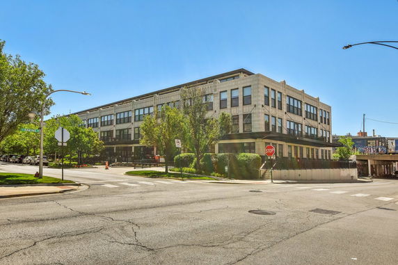 Street view of a mid-rise building with a modern facade.