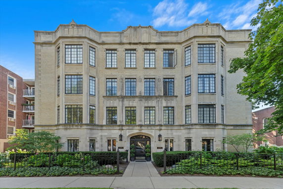 Front view of a multi-story building with large windows and masonry exterior.