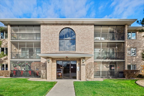 Front view of a multistory residential building with balconies.