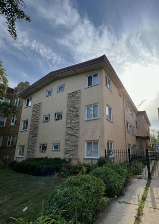 Front view of a multi-story residential building with brick exterior.