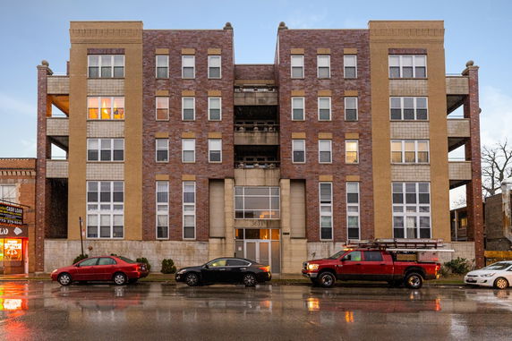 Front view of a multi-story brick apartment building.