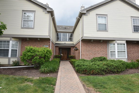 Front view of a house with brick and siding exterior.