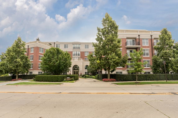 Front view of a multi-story building with a symmetrical design and large windows.
