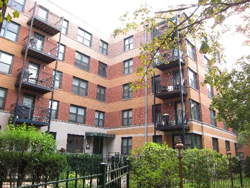 Front view of a multistory apartment building with balconies.
