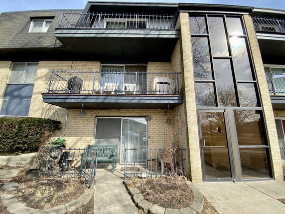 Front view of a multi-story building with balconies.