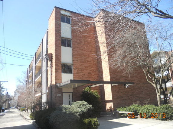 Front view of a multi-story brick apartment building.