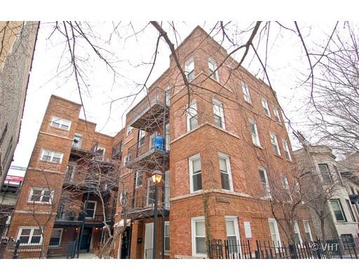 Front view of a multi-story brick apartment building.